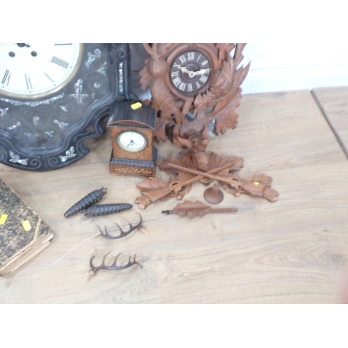 13 - An ebonised Wall Clock with mother of pearl inlay and having circular dial, 2ft 2in, a small inlaid ... 