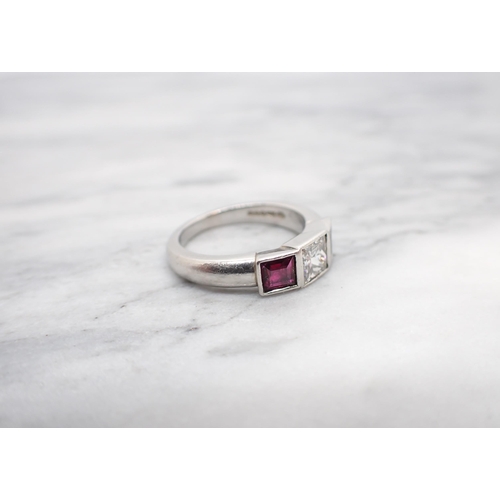 160 - A Diamond and Ruby three stone Ring invisibly-set princess-cut diamond, estimated 0.50cts, between t... 