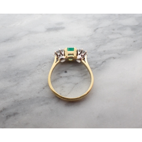 162 - A three stone Ring claw-set step-cut emerald, 1.40cts, between two brilliant-cut synthetic stones in... 