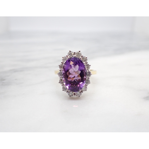 173 - An Amethyst and Diamond Cluster Ring claw-set oval mixed-cut amethyst, 3.14cts, within a frame of fo... 