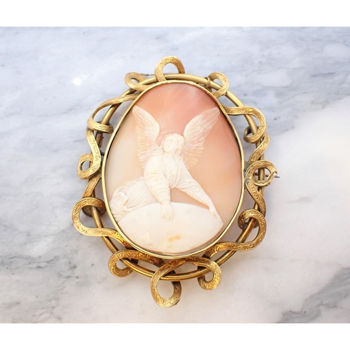 195 - A carved shell Cameo Brooch depicting angel in scrolled and engraved yellow metal frame, 6.5cm x 8cm