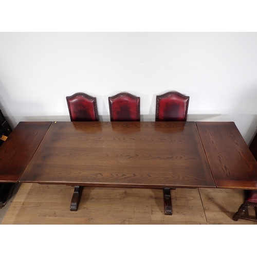 240 - An oak draw leaf Refectory Table 6ft W x 2ft 6in H and eight red leather covered oak Dining Chairs