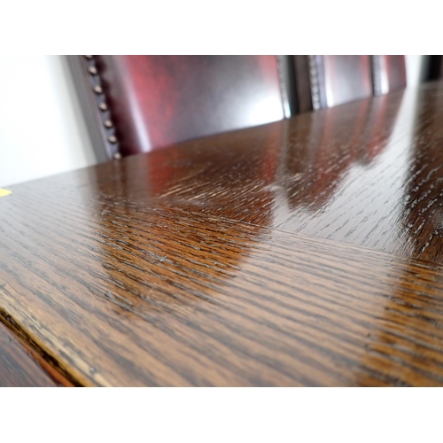 240 - An oak draw leaf Refectory Table 6ft W x 2ft 6in H and eight red leather covered oak Dining Chairs