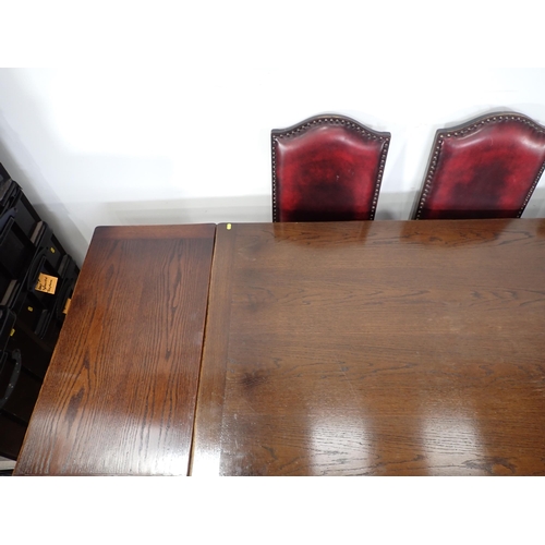 240 - An oak draw leaf Refectory Table 6ft W x 2ft 6in H and eight red leather covered oak Dining Chairs