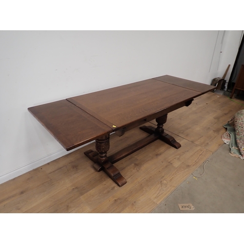 254 - An oak draw leaf Dining Table 4ft 6in W x 2ft 6in H and six brown leather effect covered Dining Chai... 