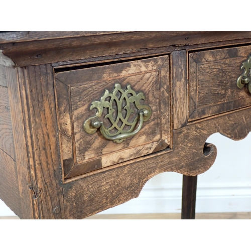 34 - A Georgian oak Lowboy fitted three frieze drawers above a shaped frieze on chamfered squared support... 