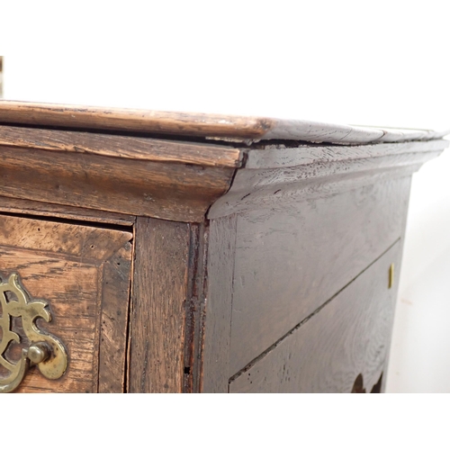 34 - A Georgian oak Lowboy fitted three frieze drawers above a shaped frieze on chamfered squared support... 