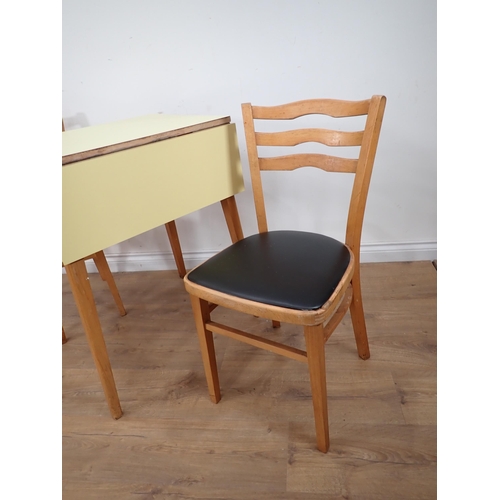 379 - A melamine topped dropleaf Table and two Chairs