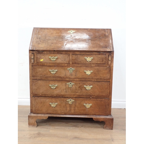 393 - A Georgian style walnut  and feather banded Bureau with fall front enclosing fitted interior above t... 