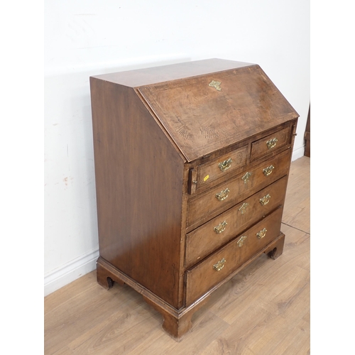 393 - A Georgian style walnut  and feather banded Bureau with fall front enclosing fitted interior above t... 