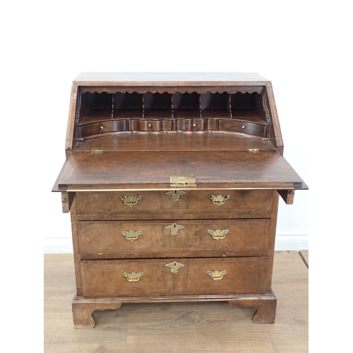 393 - A Georgian style walnut  and feather banded Bureau with fall front enclosing fitted interior above t... 