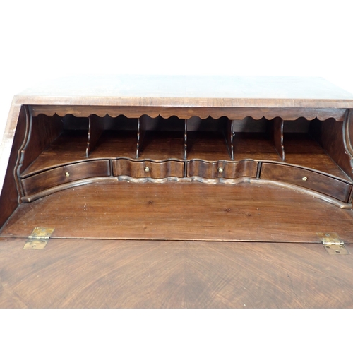 393 - A Georgian style walnut  and feather banded Bureau with fall front enclosing fitted interior above t... 