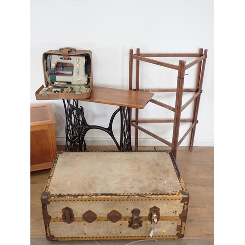 4 - A Lloyd Loom Armchair, a Blanket Box, a large Trunk, a Cresta Sewing Machine, a Table made from a tr... 