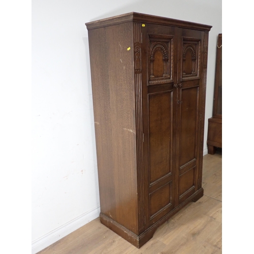 469 - An oak two door Wardrobe with arcaded panel doors 5ft 6in H x 3ft 4in W