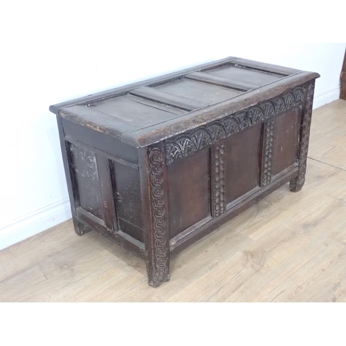 474 - A 17th Century oak Coffer with sunken three panel lid above lunette carved frieze and three panel fr... 