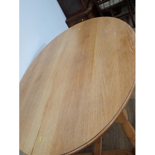 495 - A modern oval oak Dining Table on turned supports with H-stretcher 5ft W x 2ft 6in H