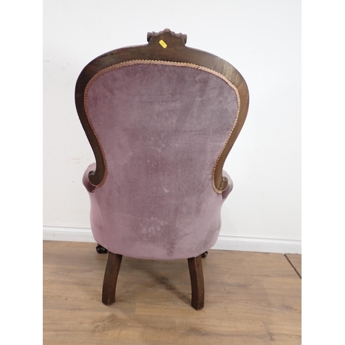 516 - A Victorian mahogany framed button back Armchair with purple upholstery