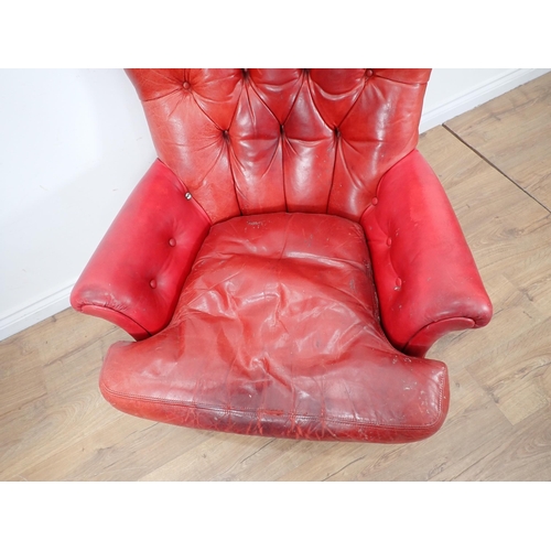 73 - A red leather upholstered button back Armchair on mahogany turned supports