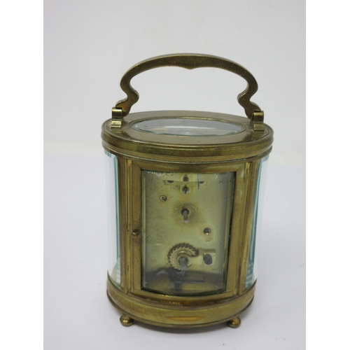 93 - A brass cased oval Carriage Clock with white enamel circular dial, cylinder escapement, 6in, in orig... 