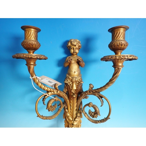 502 - A pair of antique gilded metal two branch Wall Lights with putti, leafage and ribbon design