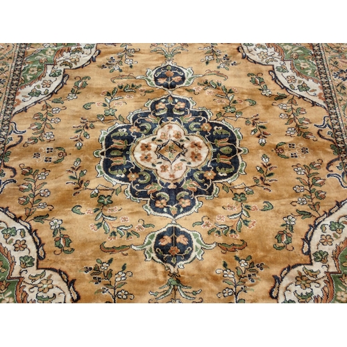 9 - A Burlap Rug with central medallion, floral designs on a brown ground, 10ft 2in x 7ft 2in