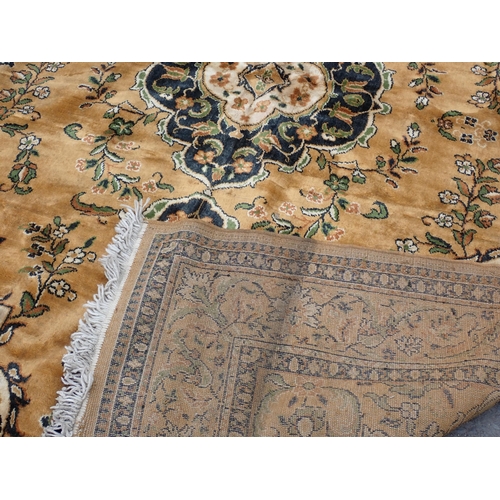 9 - A Burlap Rug with central medallion, floral designs on a brown ground, 10ft 2in x 7ft 2in