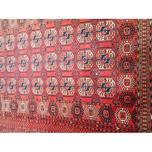 350 - A Persian red ground Rug with three rows of medallions within multiple borders 7ft 10in L x 4ft 8in ... 