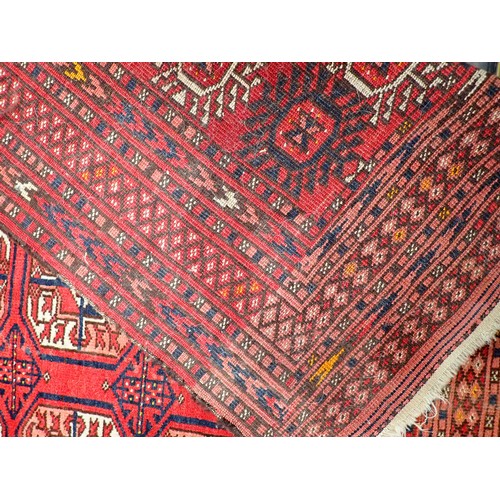 350 - A Persian red ground Rug with three rows of medallions within multiple borders 7ft 10in L x 4ft 8in ... 