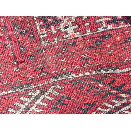 351 - A Persian red ground Rug with two rows of medallions within multiple borders 6ft L x 4ft 4in W and a... 