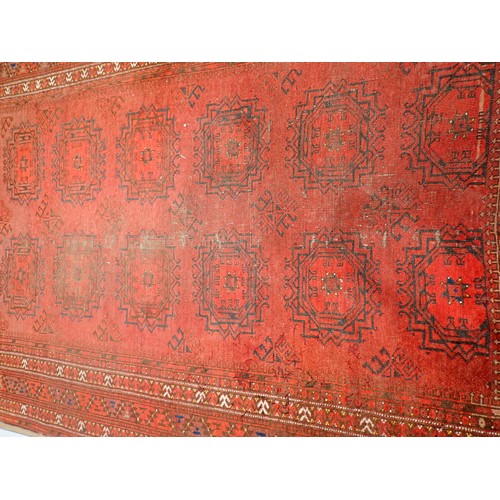 352 - A red ground Persian Rug with two rows of stylised flowers amongst border with flower heads 7ft 2in ... 