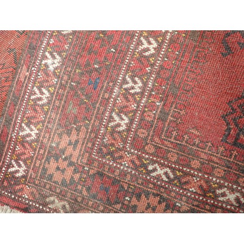 352 - A red ground Persian Rug with two rows of stylised flowers amongst border with flower heads 7ft 2in ... 