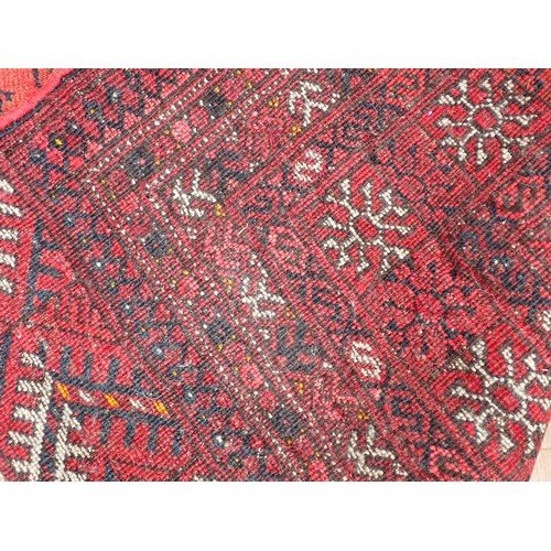 353 - A red ground Persian Rug with three roes of medallions with wide border (tear to side) 6ft 3in L x 4... 