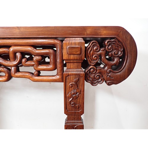 1 - A Chinese hardwood Serving Table with carved and pierced frieze, the squared supports with surface c... 