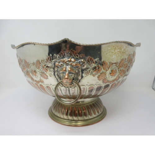 134 - A plated on copper Punch Bowl, semi-fluted embossed floral swags, lion mask and ring handle, 13in di... 