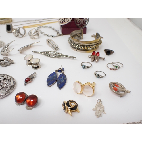 194 - A collection of silver and white metal Brooches, Bangles, Bracelets etc