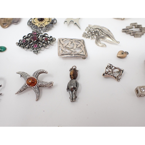 194 - A collection of silver and white metal Brooches, Bangles, Bracelets etc