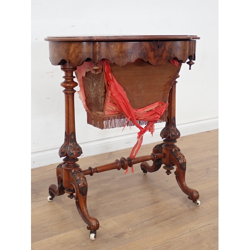 250A - A Victorian walnut Sewing Table with hinged oval top (warped) on carved cheval base, silk A/F