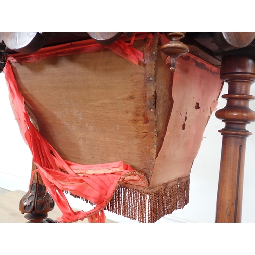 250A - A Victorian walnut Sewing Table with hinged oval top (warped) on carved cheval base, silk A/F