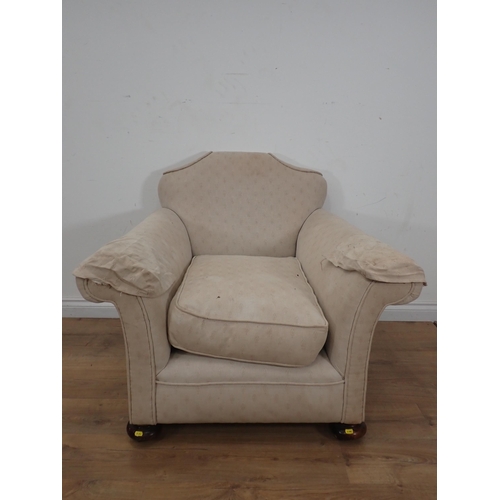 260 - An antique beige upholstered Armchair on bun feet 3ft 2in W x 2ft 7in H