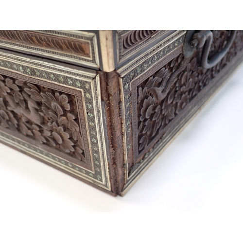 288 - An antique Anglo-Indian sandalwood Box of sarcophagus form with carved leafage decoration and ivory ... 