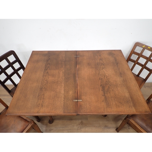 289 - An oak veneered fold over Dining Table and four Chairs