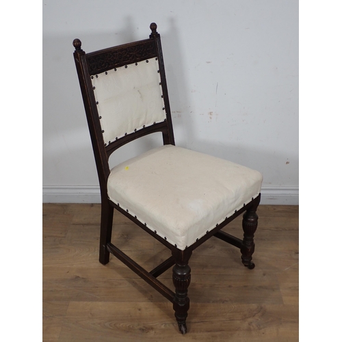 308 - A pair of Edwardian oak framed Chairs with cream upholstery