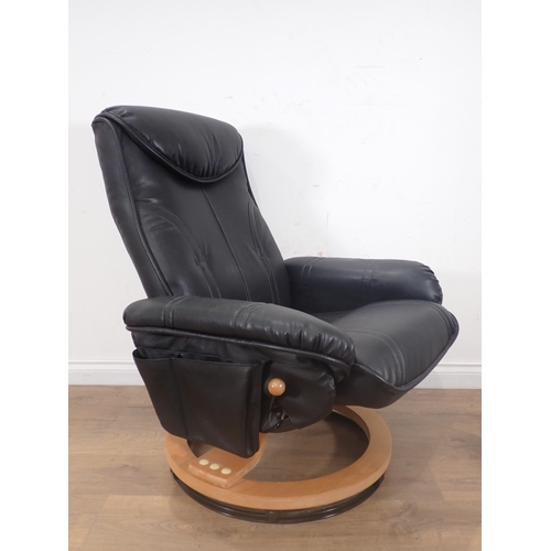 32 - A leather effect covered Armchair and Footstool