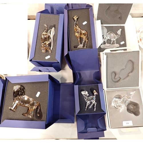 354 - Six boxed Swarovski Animales including Camel, Giraffe, Leopard, two Lions and a Fawn