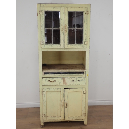 622 - A cream painted Kitchen Cabinet with two door lead glazed upper section above base fitted single dra... 