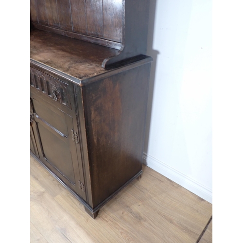 625 - An oak Dresser and Rack fitted two frieze drawers above pair of panelled cupboard doors 6ft H x 4ft ... 