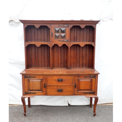 626 - An Arts and Crafts oak Dresser and Rack fitted pair of cupboard doors and two drawers mounted on squ... 