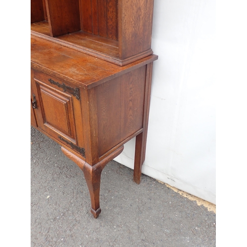 626 - An Arts and Crafts oak Dresser and Rack fitted pair of cupboard doors and two drawers mounted on squ... 