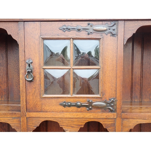 626 - An Arts and Crafts oak Dresser and Rack fitted pair of cupboard doors and two drawers mounted on squ... 