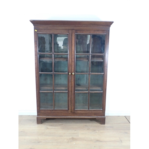 629 - An oak Bookcase fitted pair of glazed doors enclosing shelves on bracket feet 5ft 3in H x 3ft 11in W